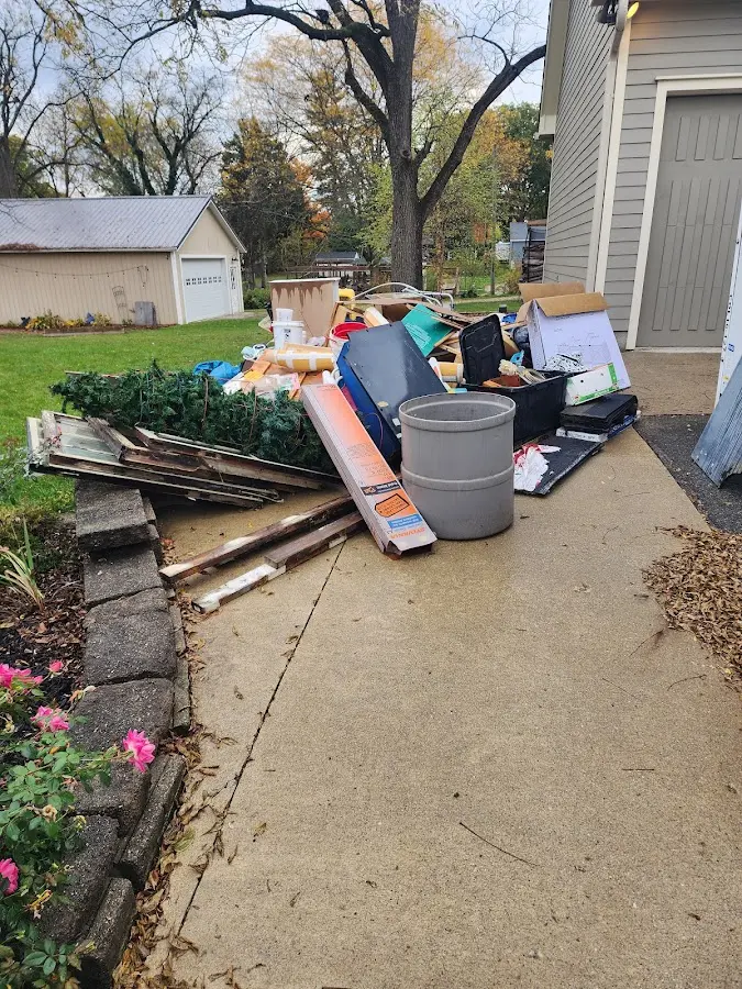 Dumpster being loaded with debris for 12 Yard Dumpster Rental in Tualatin